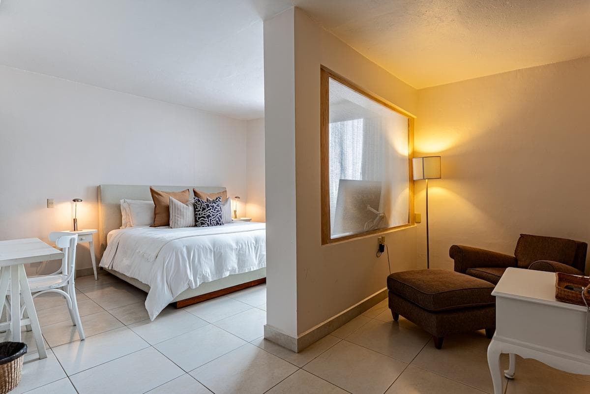 Unwind in your private retreat: king bed, workspace, TV and comfy lounge.