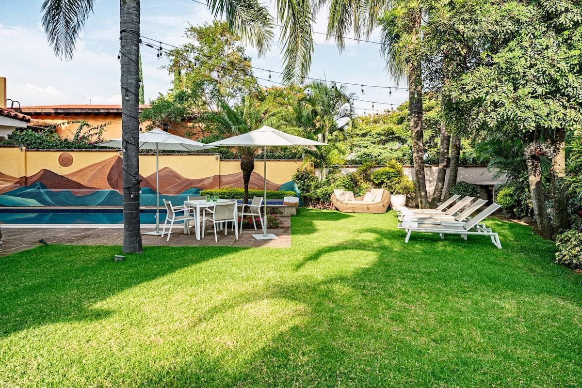 Relax poolside in Cuernavaca's charming garden, with loungers and outdoor dining.
