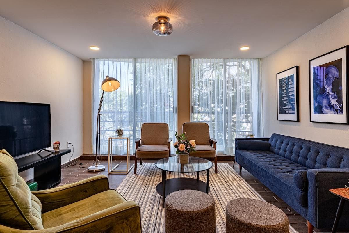 Cozy living area with comfortable seating and unique artwork for a personal touch.