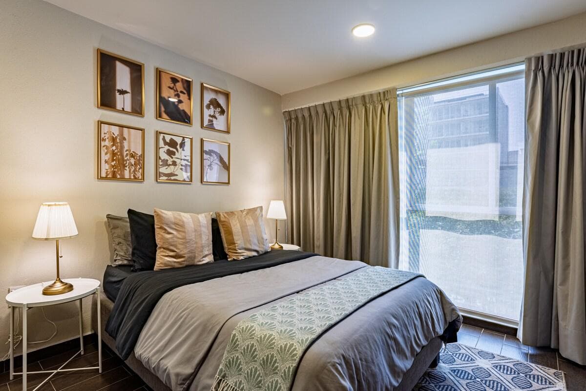 Tastefully decorated room with modern accents and cozy bedding.