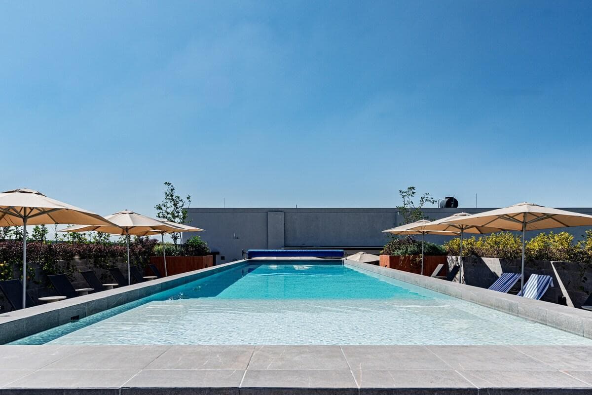 Trade city energy for rooftop calm. Dive in.