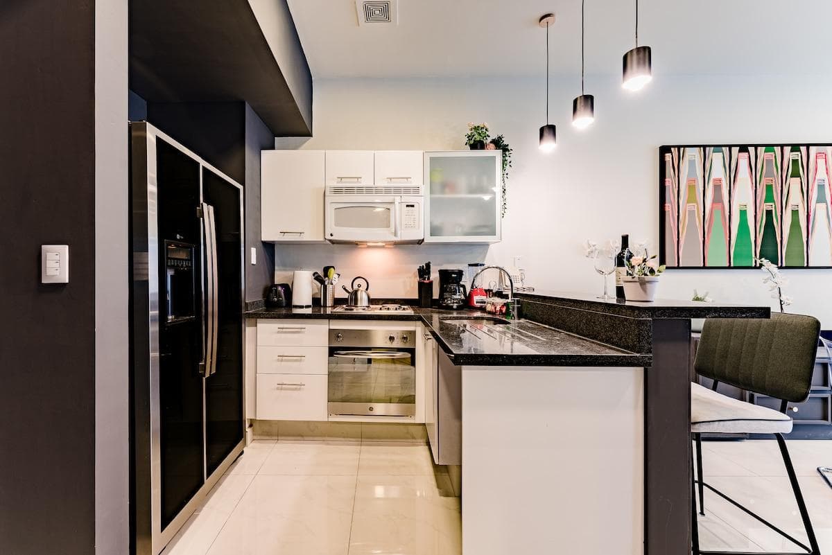 Fully equipped kitchen with high-end appliances and breakfast bar.