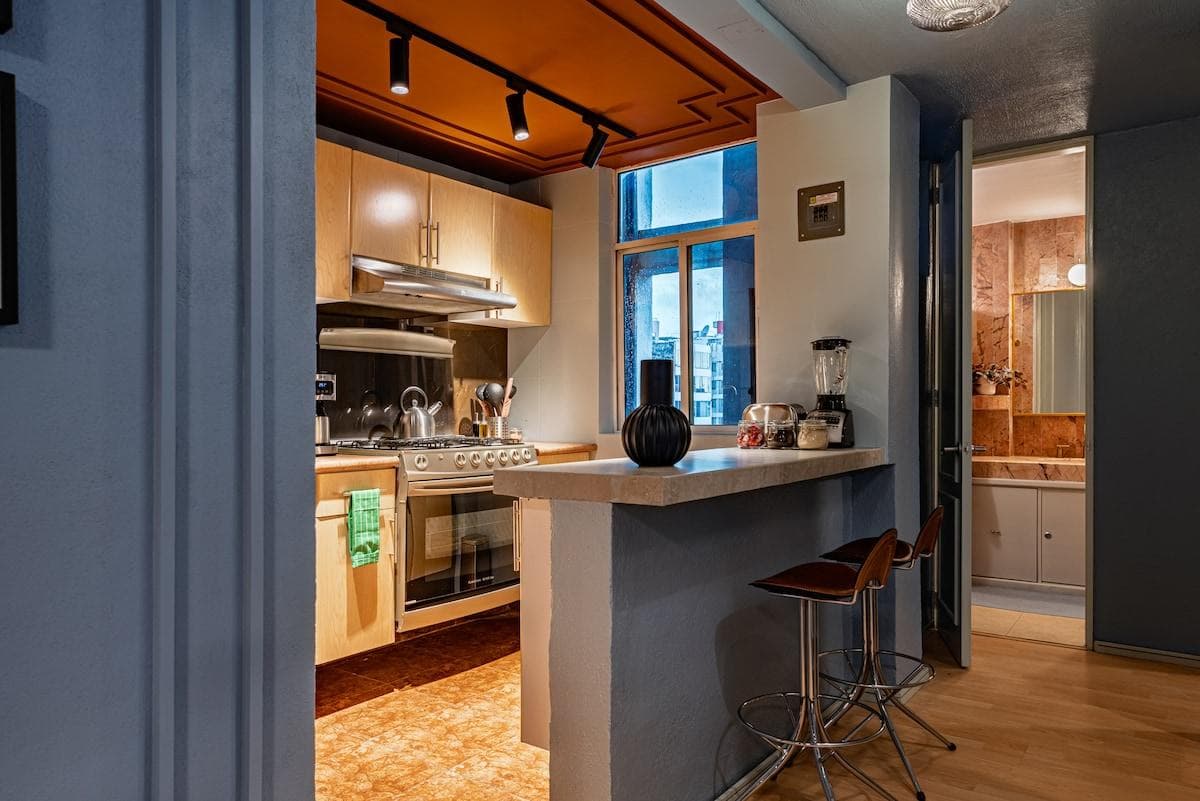 Fully equipped kitchen with essential appliances and a convenient breakfast bar.