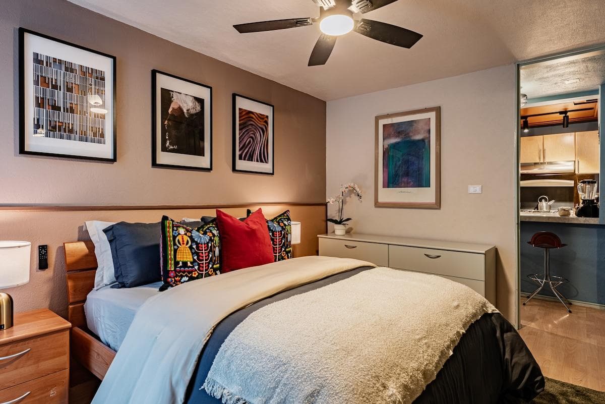 Comfortable bedroom with a king-size bed, a warm lighting, and modern decor.