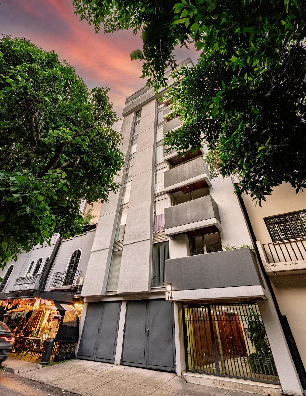 Exterior view of the building surrounded by greenery.