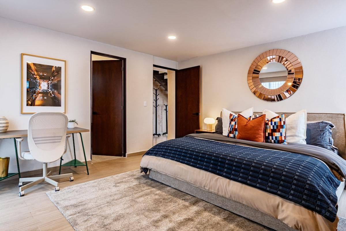 Spacious bedroom 1 with a comfortable king bed, dedicated workspace, and warm décor.