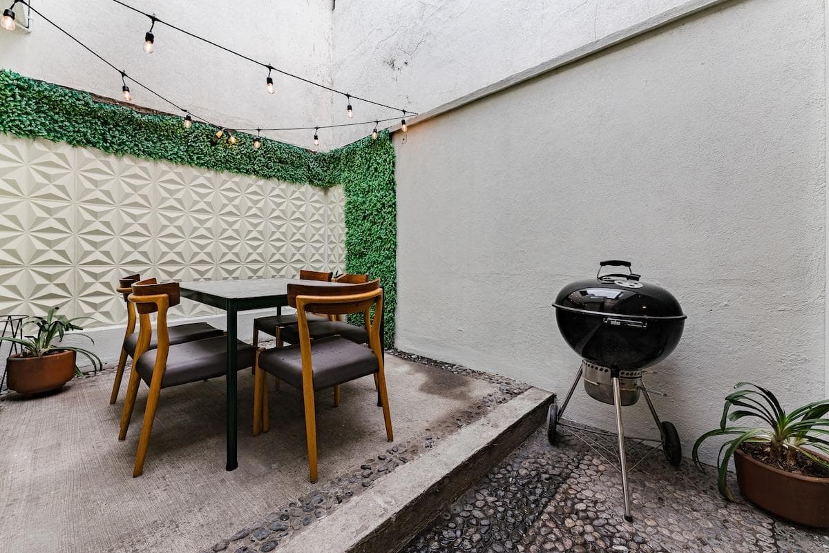 Private patio with BBQ and outdoor seating, ideal for al fresco dining.