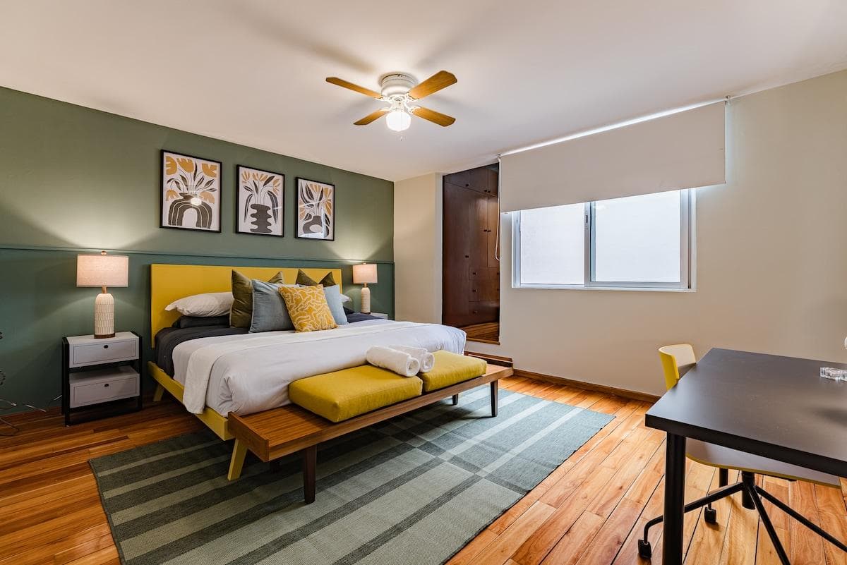 Comfortable bedroom with bright decor and plenty of natural light.