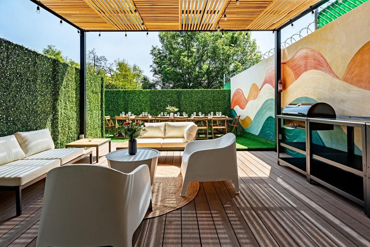 Covered lounge area on the rooftop with colorful murals