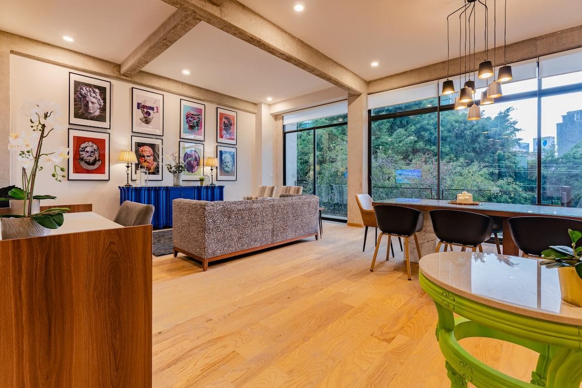 A colorful gallery wall adds personality to this airy, open-concept living area.