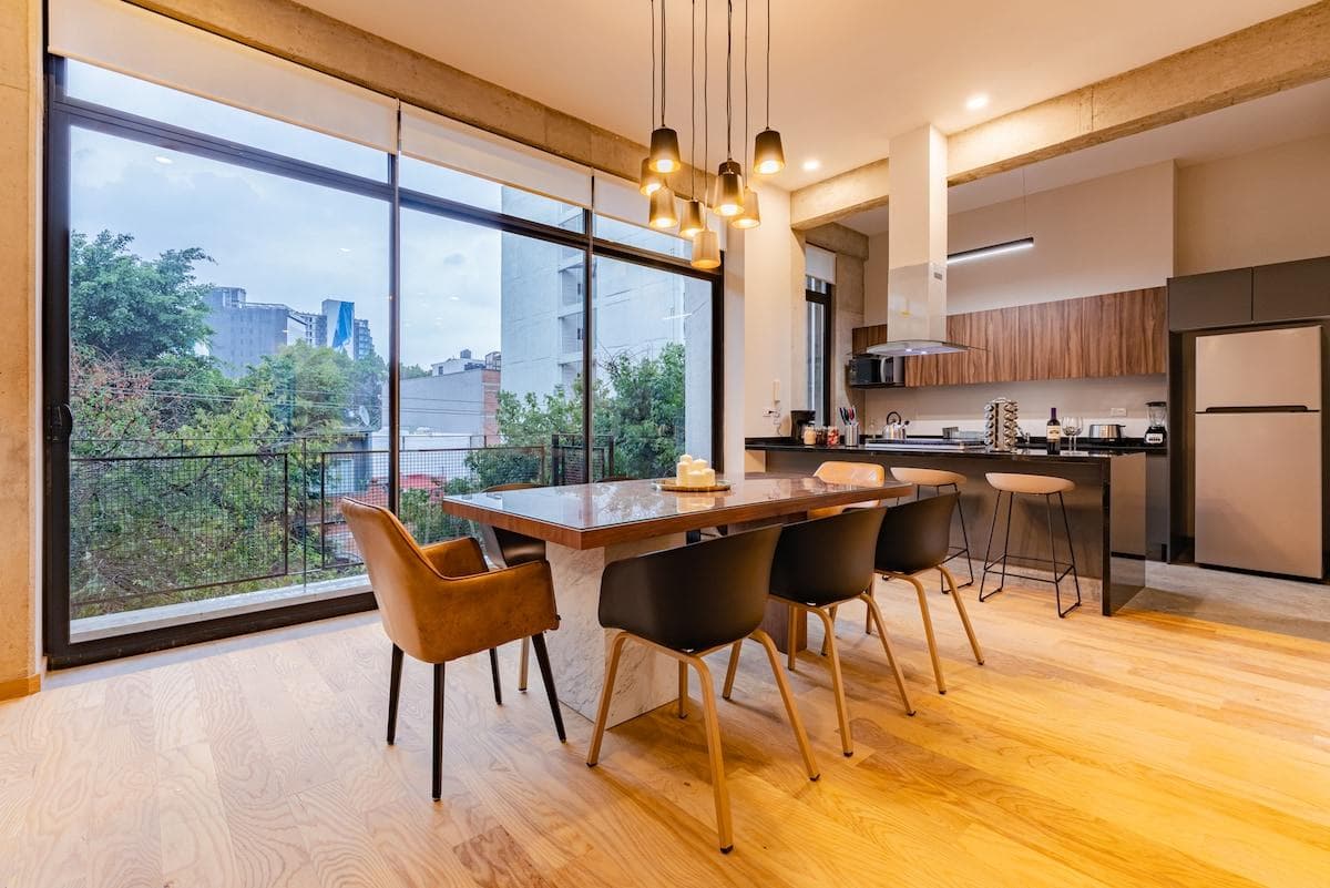 Enjoy dining in style with large windows showcasing the surrounding greenery.