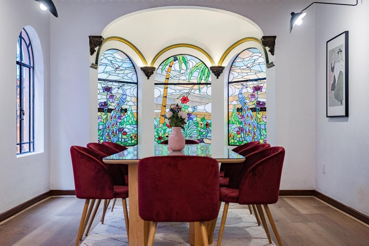 Dining room decorated with stained glass windows.