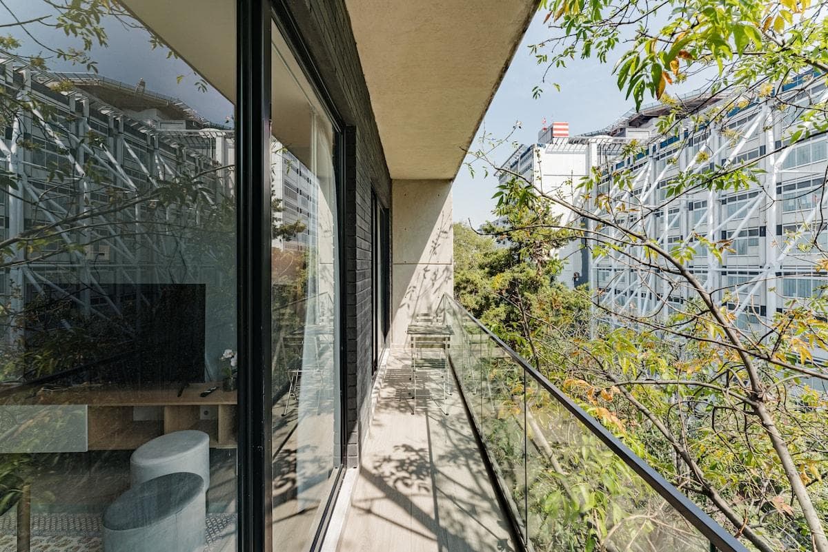 Floor-to-ceiling windows bring nature indoors with treetop views