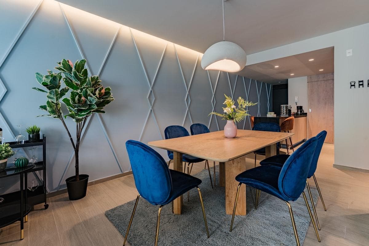 Modern dining area with trendy seating and chic lighting