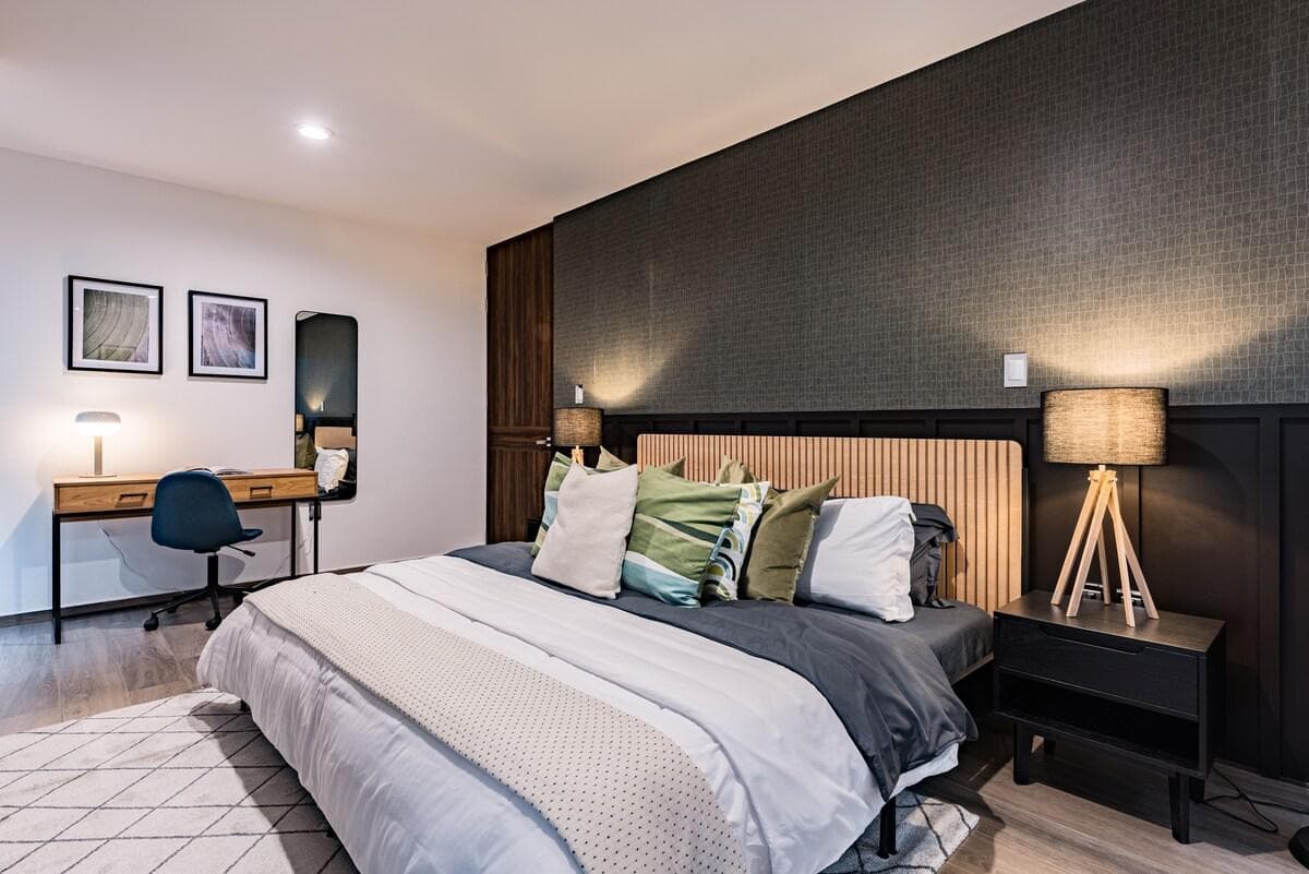 Master bedroom featuring a cozy king-size bed and chic, calming decor.