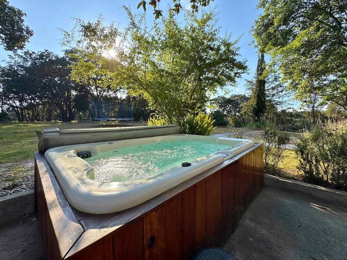 The private jacuzzi offers a peaceful escape surrounded by greenery.