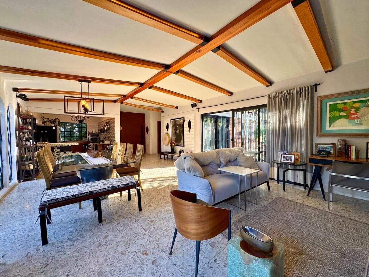 The spacious living area connects seamlessly to dining and outdoor spaces.