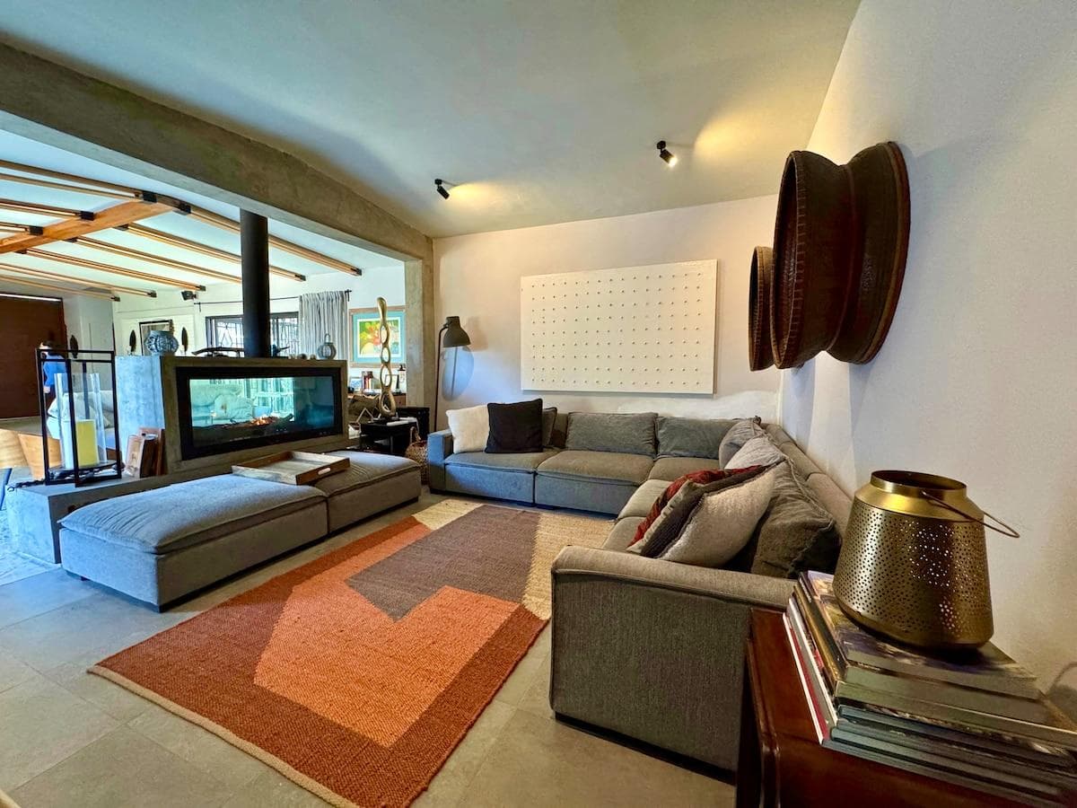 Relax in the cozy living room featuring a warm fireplace and stylish decor.