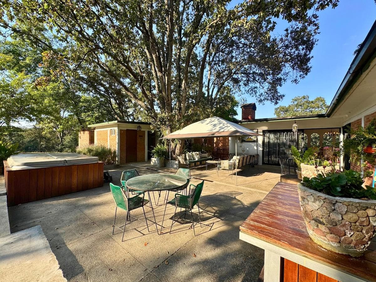 Unwind outdoors with seating perfect for gatherings under the trees.