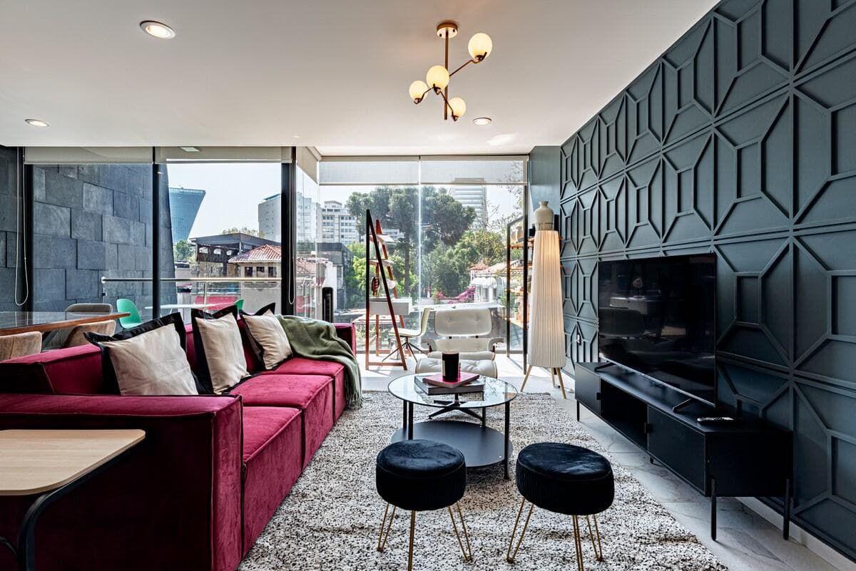 Relax in the stylish living room with plush seating and floor-to-ceiling windows
