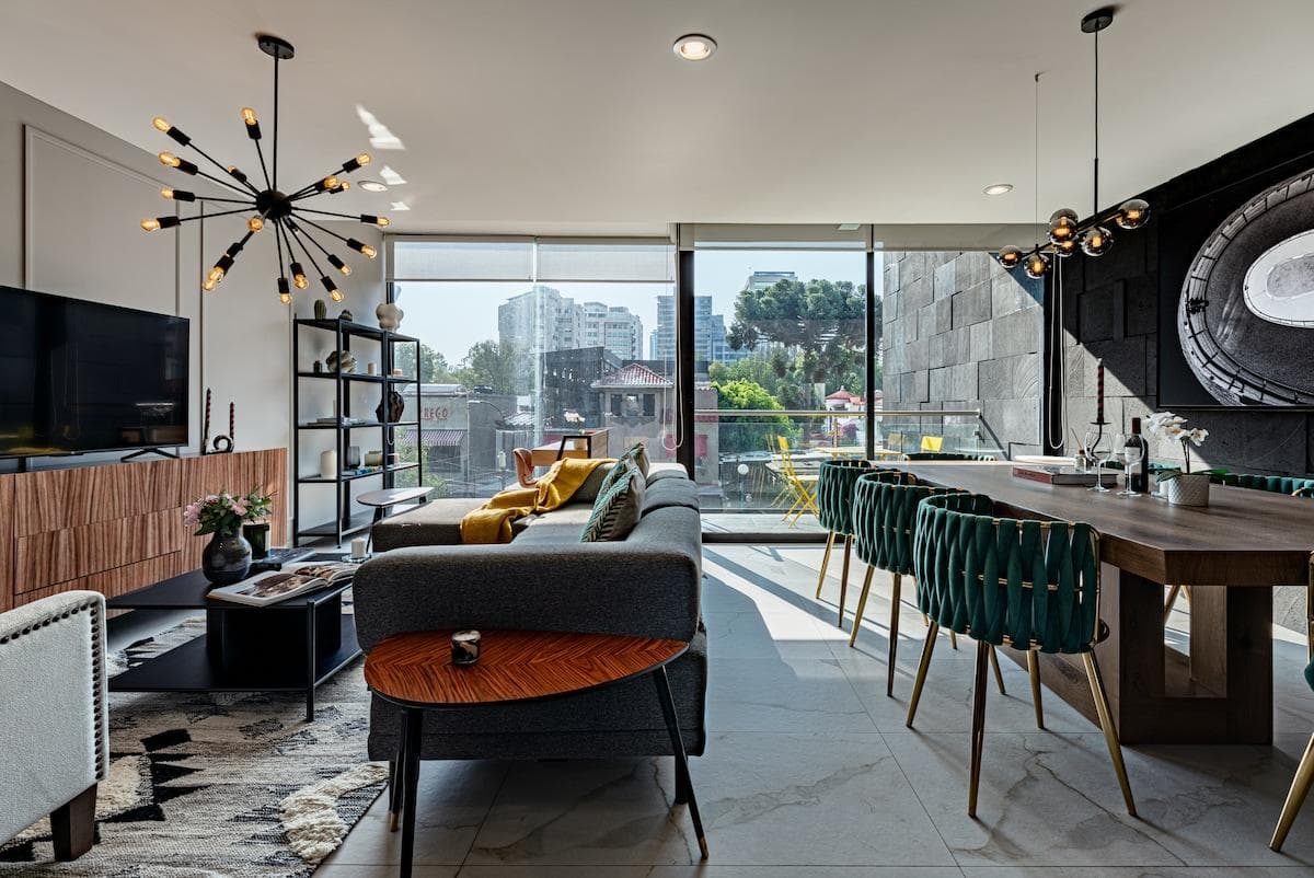 Open-concept living and dining area with floor-to-ceiling windows and modern decor