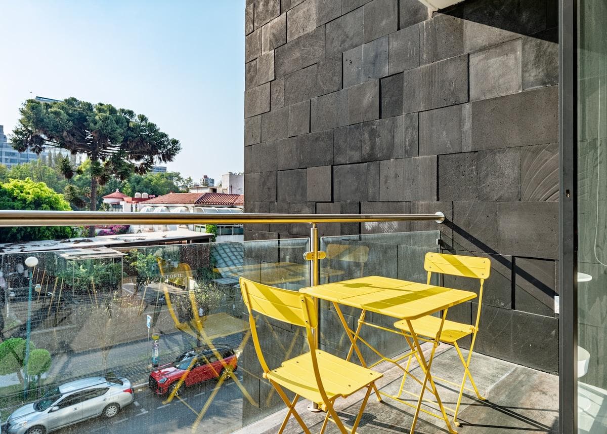 Private balcony with colorful seating, perfect for morning coffee or sunset drinks