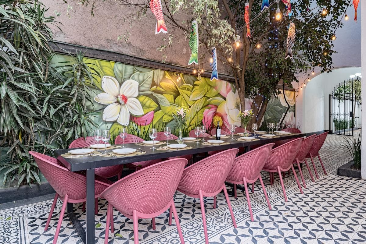 Outdoor dining with tropical murals and colorful seating