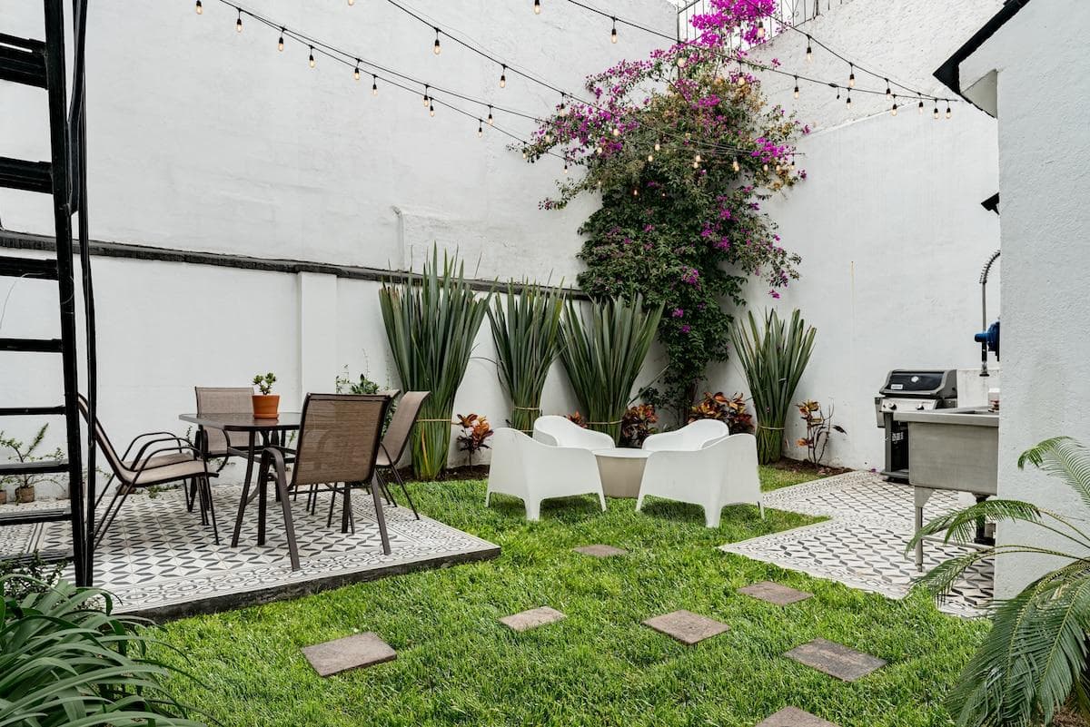 Private courtyard with cozy seating and lush greenery
