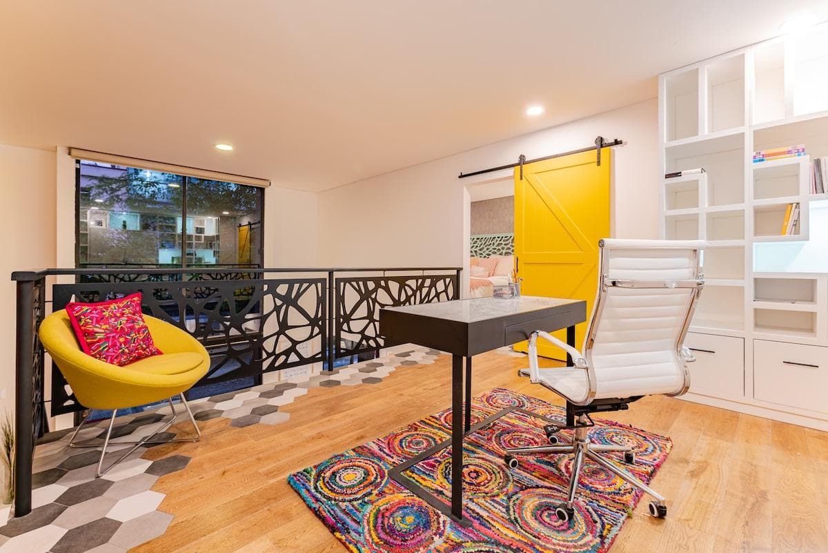 Cozy seating area in the loft with colorful pillows and natural light.