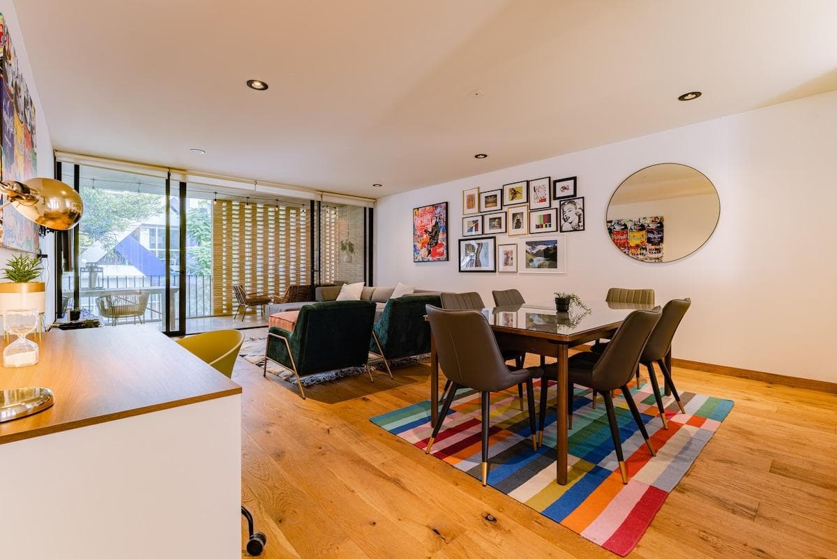 Open-plan living and dining area, filled with light and art.