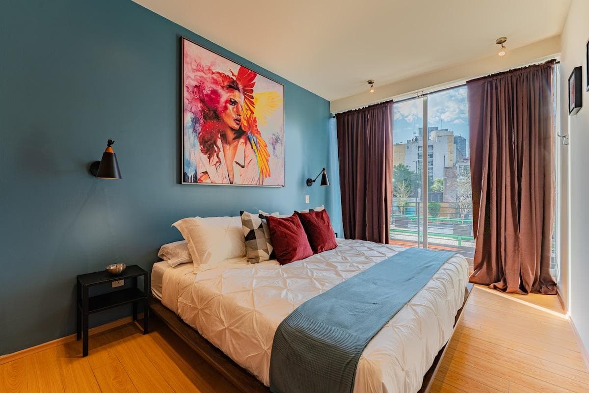 A stylish bedroom retreat with unique wall art and room-darkening shades