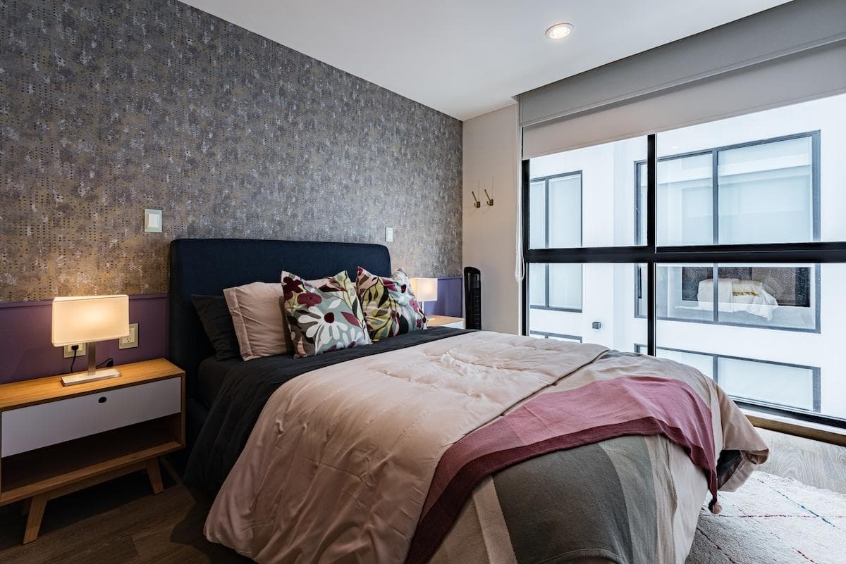 Charming second bedroom with a comfortable double bed and stylish, minimalist decor, perfect for a peaceful night’s sleep.