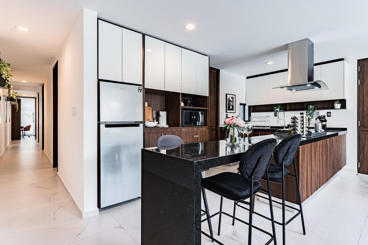 Sleek, fully equipped kitchen with a spacious island and premium appliances, ready for all your culinary creations.