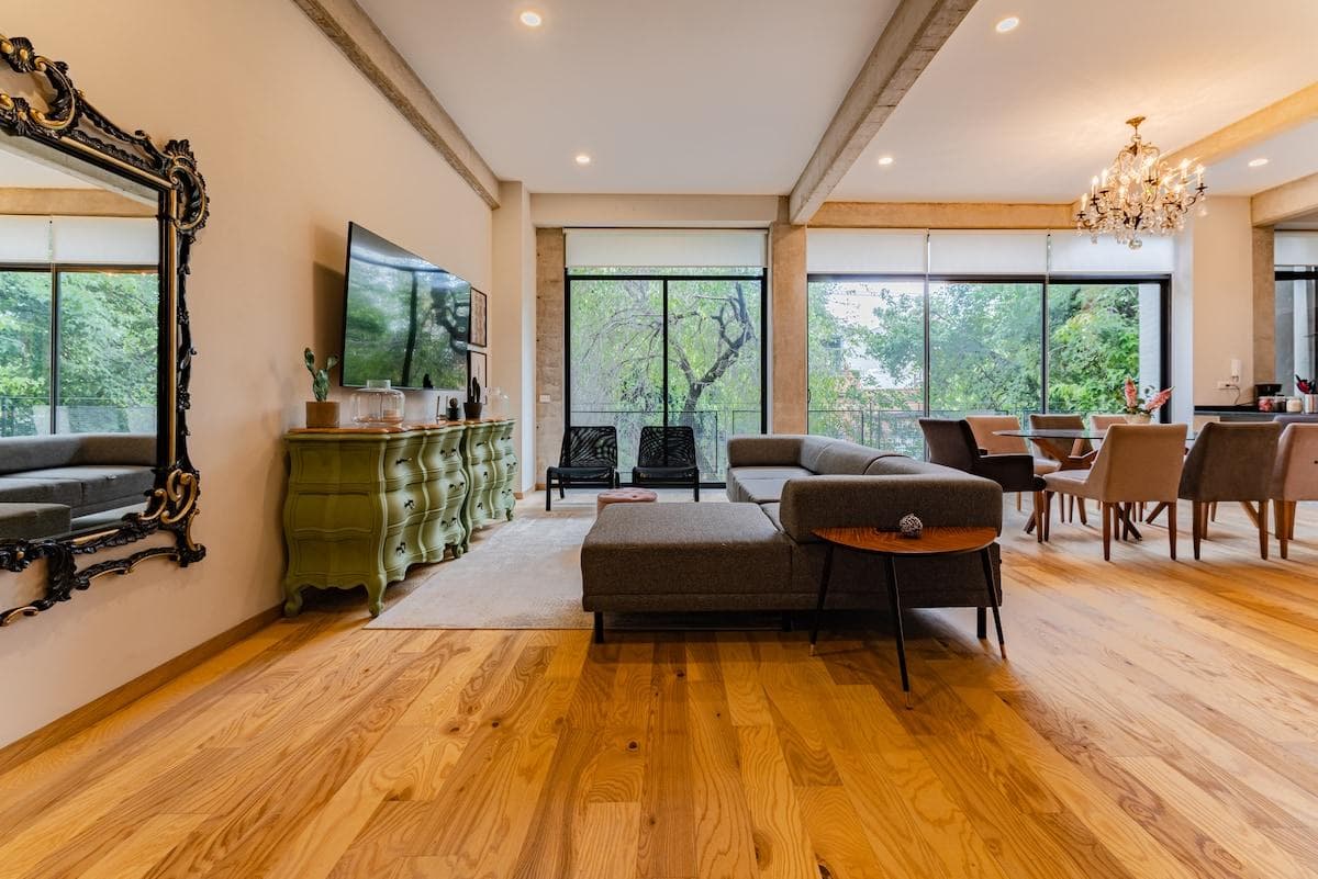 Wall-to-wall windows offering abundant light and serene green views.